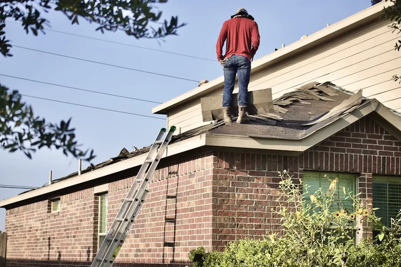 Professional roofer working on a residential roof in Weyanoke
